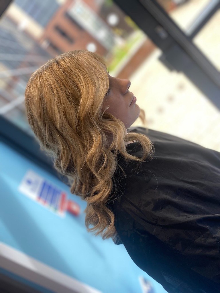 Caramel blonde waves with a fringe