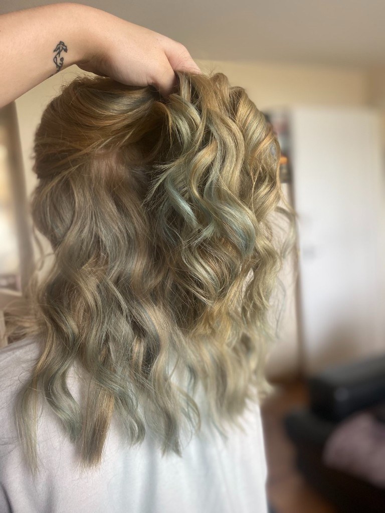 Wavy hair with a soft sage tone